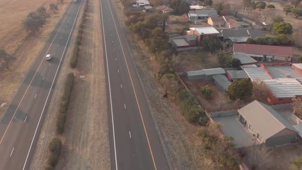 AERIAL shot of a neighbourhood next to the national road