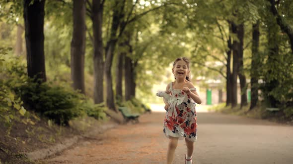Young Children Enjoy Playing Funny Activity Together With Father. Little Girl Running To Parents.