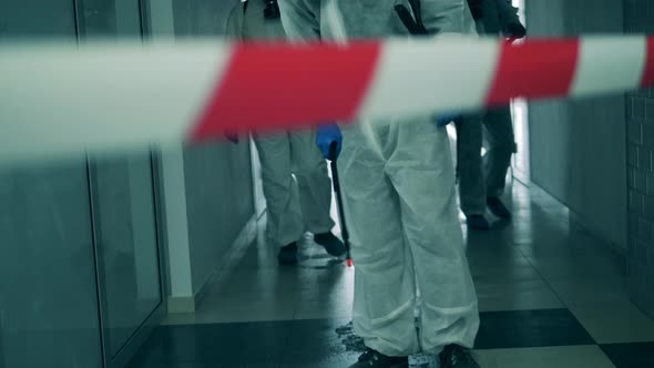 Disinfectors Spray Antiseptic in Corridor During Pandemic.