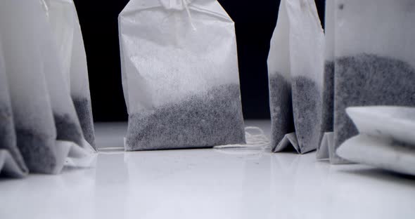 Super Closeup Set of Tea Bags on a White Table on a Black Background
