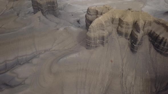 Aerial view flying over small mesas viewing eroded terrain