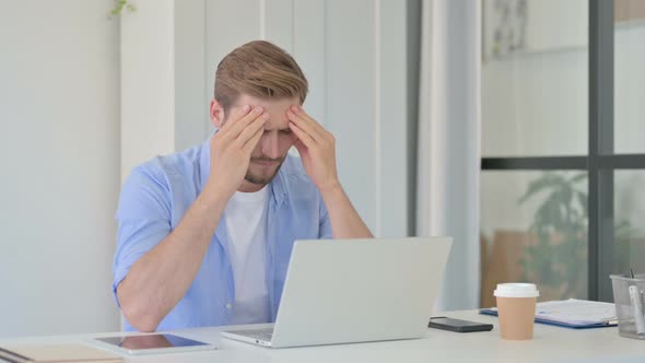 Young Creative Man Having Headache at Work