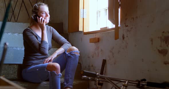 Woman Talking on Mobile Phone at Workshop 