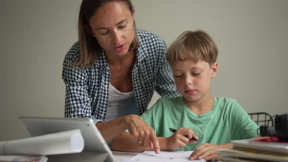 Mother and 8 Year Old Son Doing Homework