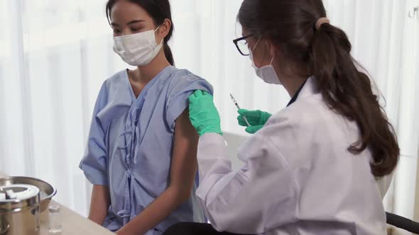 Young Woman Visits Skillful Doctor at Hospital for Vaccination