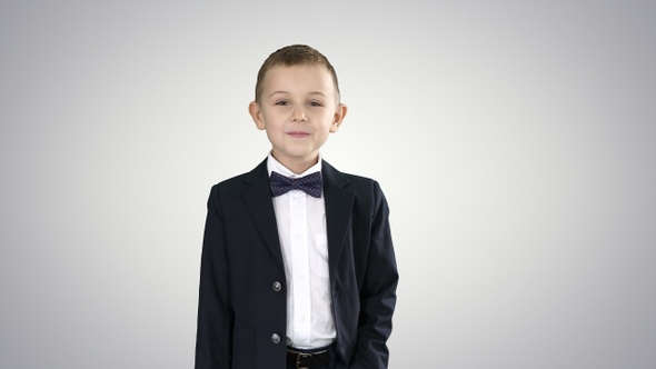 Boy in formal costume walking with a hand in pocket on