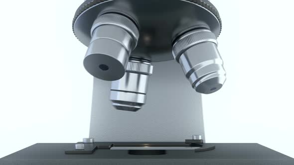 Laboratory Microscope in Bright White Laboratory Rotating its Metal Lenses alt