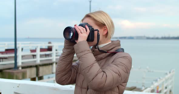 Beautiful Female Photographer Photographs the Ocean