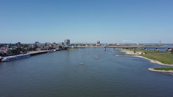 Railroad Bridge with yellow train over river Waal in Nijmegen, The Netherlands