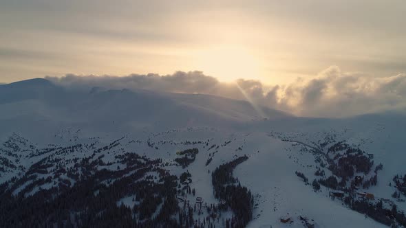 Winterland, fly over mountains in evening sunlight