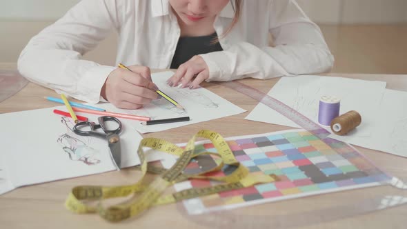 Close Up Of Female Students Or Business Owners Working On Designs In Fashion Studio