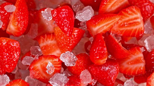 Super Slow Motion Shot of Fresh Strawberries and Crushed Ice Flying Towards Camera at 1000Fps