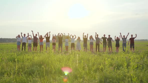 Goodbye Concept. A Group of Friends at Sunset Waving.