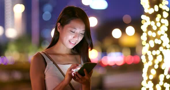 Asian woman use of mobile phone at night