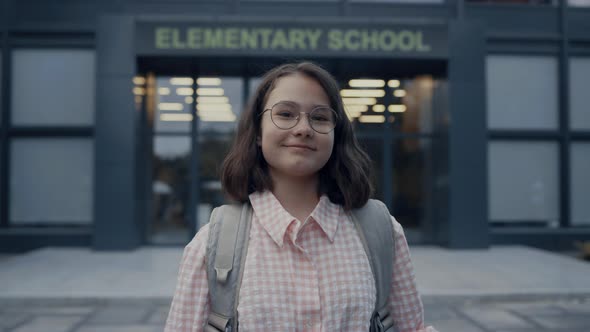 Portrait Smiling Girl Standing at School Entrance