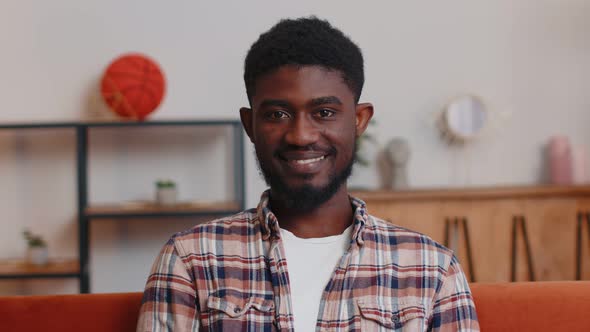 Portrait of Happy African American Teenager Student Guy Smiling Looking at Camera at Home on Sofa