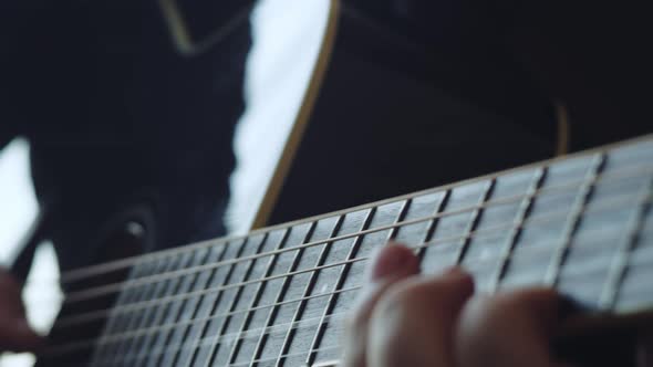 The musician plays the acoustic guitar