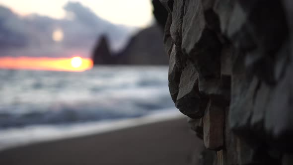 Colorful Warm Sunset Over the Sea and Volcanic Basalt Rocks Like in Iceland