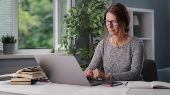 Woman Listening Audiobook at Home