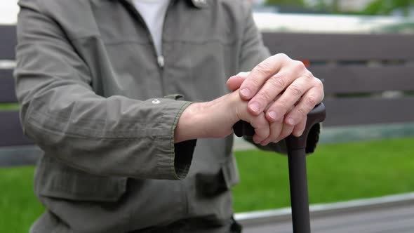 Hands of an Calm Old Man with Cane