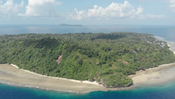 Aerial: flying over tropical Ai island white sand beach Banda Islands Maluku Ind