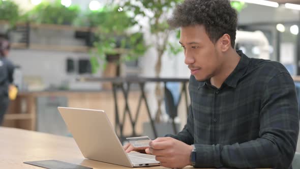 Successful Online Payment on Laptop By African American Man