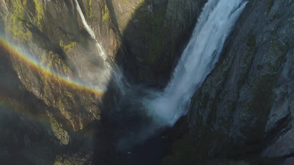 Voringfossen Waterfall in Norway with Rainbow at Sunny Summer Day