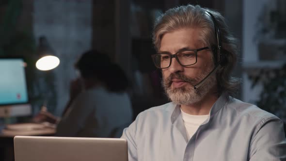 Smiling Call Center Operator In Office At Night