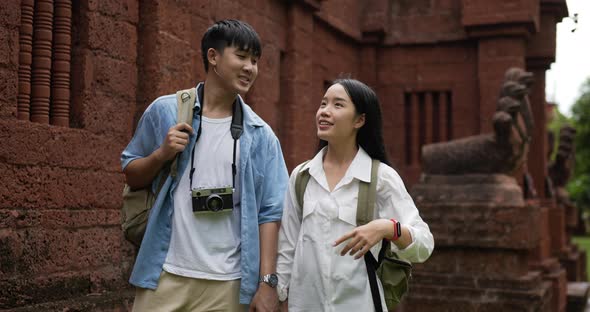 Couple hand together while visiting at ancient temple