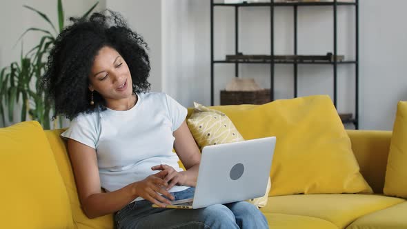 Portrait of a Young African American Woman Talking on a Video Call on Portable Laptop