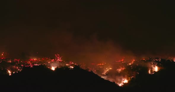  Cinematic Shot Overlooking Bushes in Flames, on a Dark Summer Night. USA