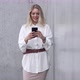 Young Woman Using Smartphone Near Wall - VideoHive Item for Sale