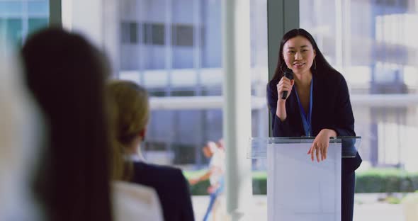 Female speaker speaks in a business seminar at modern office 4k