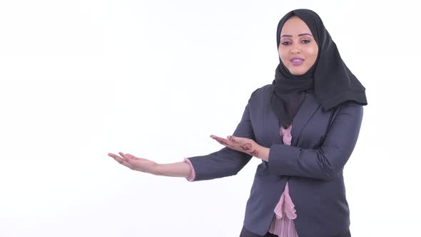 Happy Young African Muslim Businesswoman Talking While Showing Something