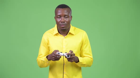 Young African Businessman Playing Games and Losing