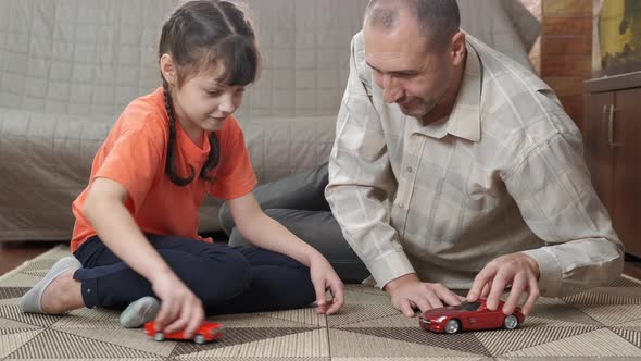 Parent with Child Play with Toy Car