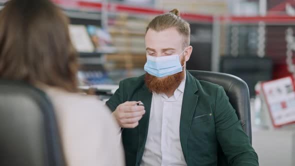 Successful Man in Covid Face Mask Clicking Car Key and Giving It To Blurred Happy Young Woman