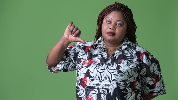 Overweight Beautiful African Woman Against Green Background