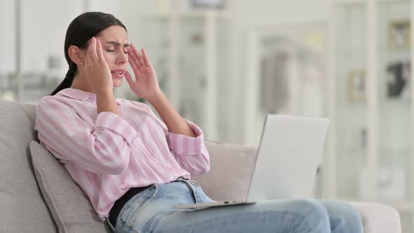 Stressed Young Latin Woman with Laptop Having Headache at Home