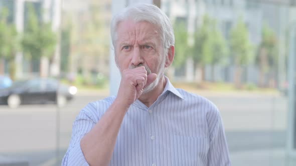Old Man Coughing While Standing Outdoor