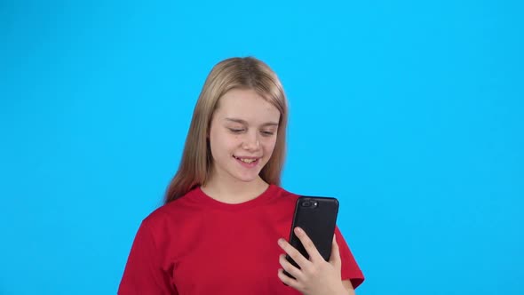 Pretty Girl Holding a Phone and Speaking with Someone Using Video Calling. Slow Motion