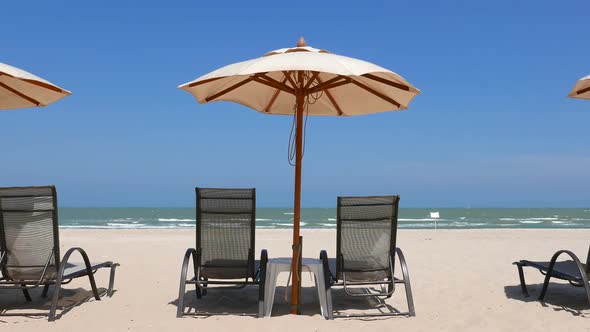 Beautiful tropical sea beach around with umbrella chair on blue sky