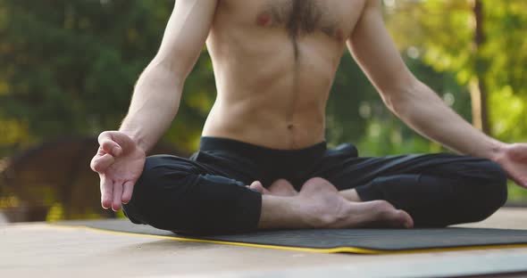 Man Sitting in Lotus Namaste Pose and Meditating