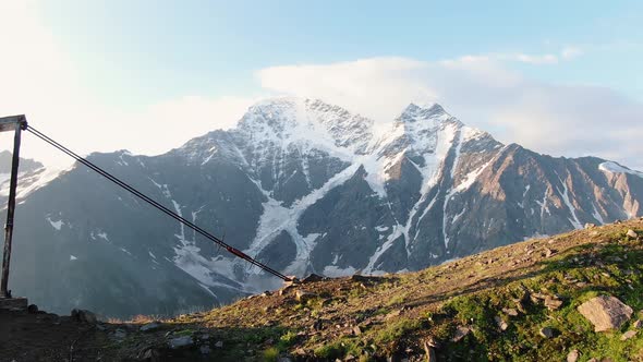 Drag Lift Posts on Bare Slope Against Snowcapped Elbrus Peak