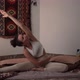 Young Woman Enjoys Yoga in Forward Bend Pose on Mat at Home - VideoHive Item for Sale