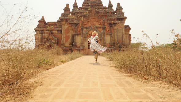 Young Tourist Woman Running in White Dress To Old Traditional Burmese Temple. Travel Adventure