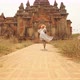 Young Tourist Woman Running in White Dress To Old Traditional Burmese Temple. Travel Adventure - VideoHive Item for Sale