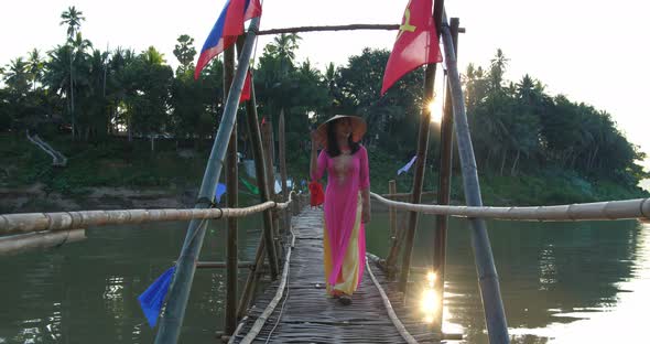 Vietnamese Girl Walking On Bamboo Bridge Cross River