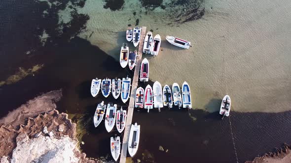 Aerial View of Several Tourist Boats Moored at a Wooden Pier on a Sunny Summer Day