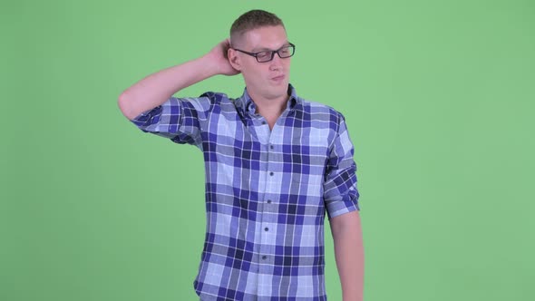 Confused Young Hipster Man Scratching Head